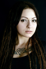 beautiful young woman with piercings and dreadlocks