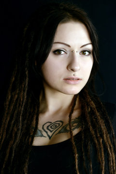 beautiful young woman with piercings and dreadlocks
