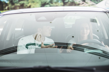 Screaming man and driving woman in a car