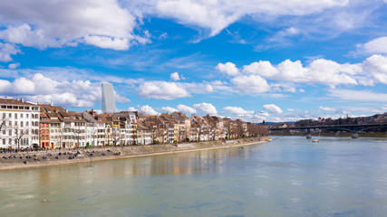View of Basel, Switzerland with old medieval buildings, river Rhine and Roche tower in the background - obrazy, fototapety, plakaty