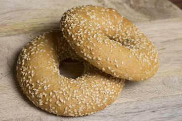 sesame bagels on wooden background
