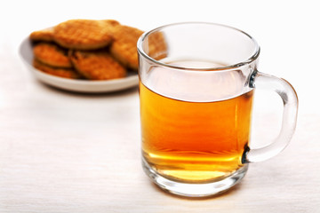 Cup of black tea and biscuits on a plate