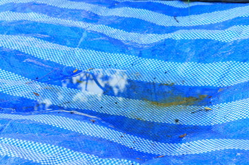 Water on the blue and white plastic canvas