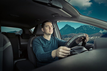 Man is traveling by car