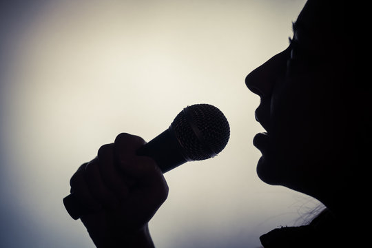 Woman singing to microphone