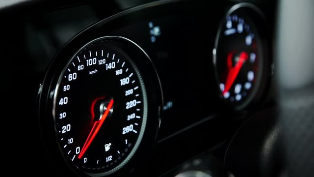 Close up shot of car speedometer, engine switch in cabin, checking before buying. user checks operation of machine, dashboard light turning on ignition, showing modern interface. techniques switching