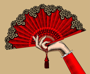 Female hand with red open fan - obrazy, fototapety, plakaty