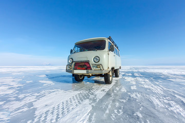 Car UAZ minibus on the ice of Lake Baikal