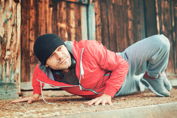 Young sportsman during his training outdoors. Sport, fitness, street workout concept