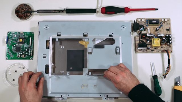 Master repair the monitor, with tools on the tabel, electronic, first-person view. 60fps.
