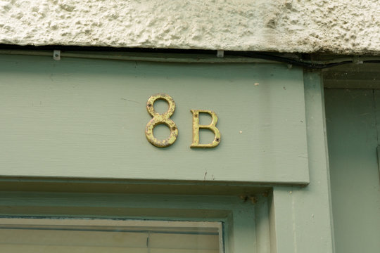 House number 8A sign  on wall