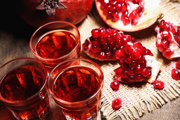 Homemade pomegranate liqueur, still life in rustic style, vintage wooden background, selective focus
