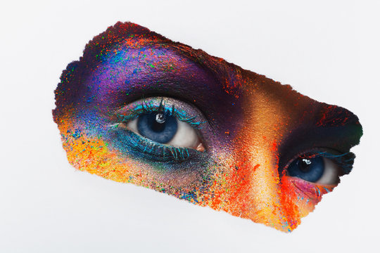 Eyes of model with colorful art make-up, close-up