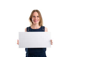 Fototapeta premium Smiling woman holding a blank white board to present something