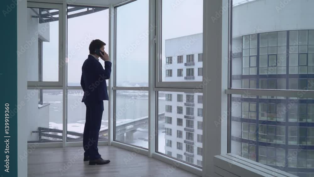 Poster man enters into the flat use smartphone has phone conversation with client. caucasian adult business