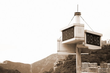 Temperature and clock monitor screen on the pole represent the whether telling technology. 