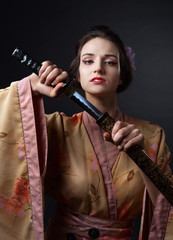  beautiful woman in traditional Japanese kimono with katana