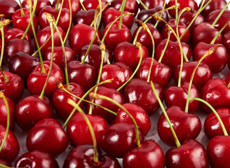 A lot of red ripe cherry isolated on white background. Close-up view.