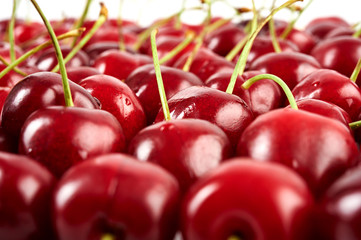 A lot of red ripe cherry isolated on white background. Close-up view.