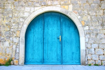 Old wooden blue door in Ston, Croatia