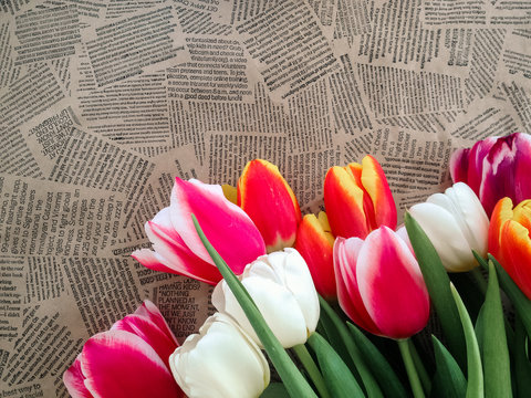 Tulips flowers bunch on Vintage newspaper background