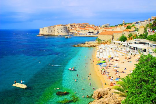 Fototapeta Dubrovnik panorama with tourists on sandy beach Banje, Adriatic sea, Croatia