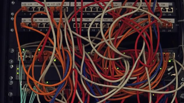 Computer network equipment and multiple plugs and cables. 4K video