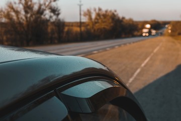 Long asphalt road at sunset. Scenic spring sunset. 