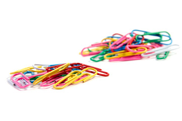 Bunch of colorful paper clips on white backgrpund