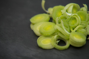 close up on fresh leek on dark rock background