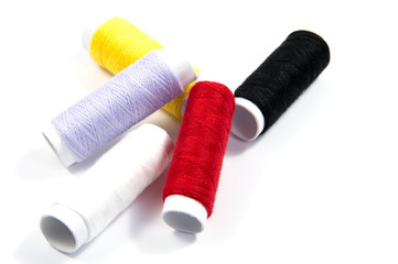 Colorful spools of thread isolated on white background