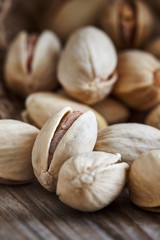 Pistachios on wooden background. Close-up with selective focus