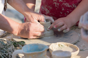 Obraz na płótnie Canvas Hands of a child learning pottery. Craft
