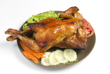 whole grilled chicken served with vegetable
