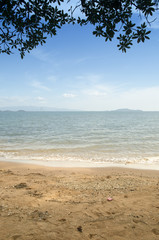Beautiful sea summer or spring abstract background. Golden sand beach with blue ocean and cloudscape and sunset in the back.
