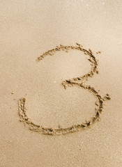 Number 3. Sand Alphabet: digits. Concept holiday background.