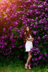 Fototapeta na wymiar young beautiful girl smiling , stay in the Park in the spring , touch of spring , girl with flowers