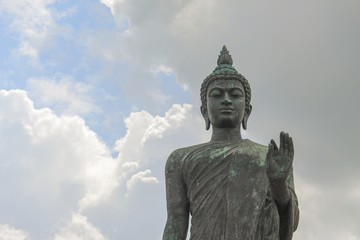 Fototapeta na wymiar Big Buddha statue ancient on blue sky background in Nakhon Pathom Province of Thailand