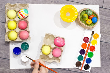  Woman painting Easter eggs. Happy easter.