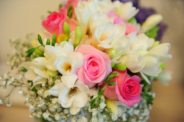 Closeup of a colorful spring bridal bouquet with roses and freesias