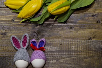 Painted Easter eggs . A bouquet of yellow tulips.
