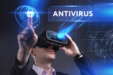 Business, Technology, Internet and network concept. Young businessman working in virtual reality glasses sees the inscription: Antivirus
