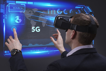 Business, Technology, Internet and network concept. Young businessman working on a virtual screen of the future and sees the inscription: 5G