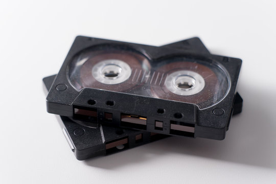 Two black audio cassette on white background