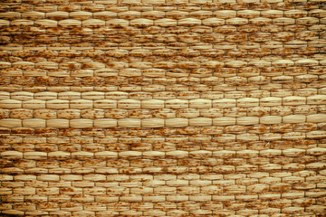 Wicker woven beige mat handmade background.