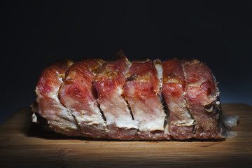 Fried pork loin on a black wooden background