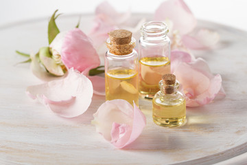 Fototapeta na wymiar Roses aroma oil for aromatherapy,pink roses petals