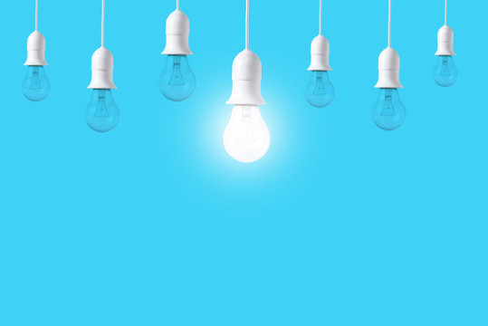 difference light bulb on blue background. concept of new ideas with innovation and creativity.