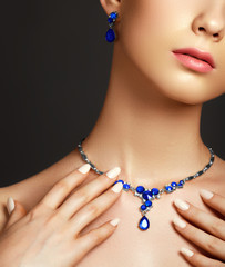 Beautiful woman with a sapphire necklace. Fashion concept