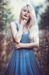Naklejka premium beautiful young woman in dress with long snow-white hair on nature